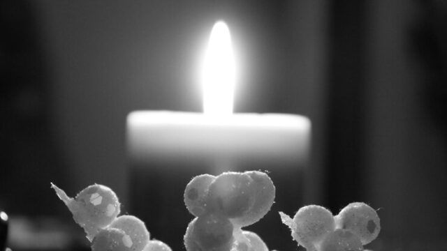 close-up-lit-candle-darkroom_1048944-21238426